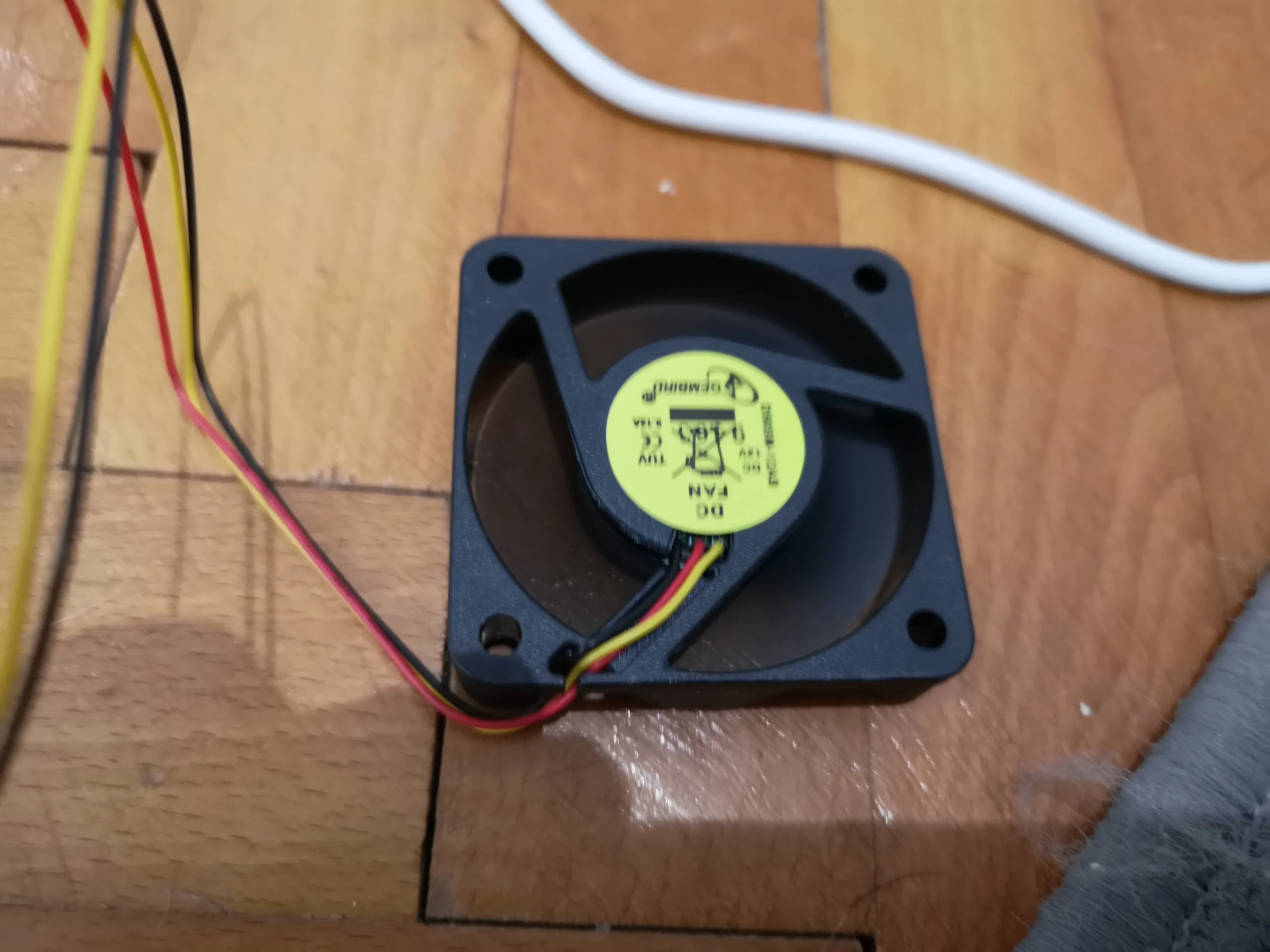 Image of a spinning PC fan connected to power